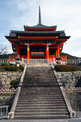 Fototapeta premium Stairs leading to red colored Zuigudo, Nishimon Temple at Kiyomizudera Temple in Kyoto in Japan