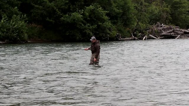 Man fly fishing for salmon and steelhead on the Kitimat River in Canada