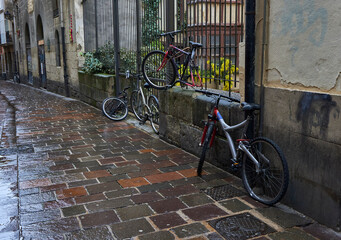 Bicycles moored and abandoned, through old streets of the Basque country