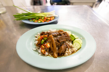 Beef stew served with rice; delicious street food in Thailand.