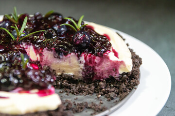 Homemade creamy cheese pie with juicy blueberry sauce and fresh blueberries. Selective focus.