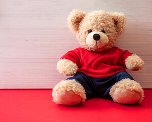 Teddy bear sitting on blue floor, child room