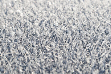 Hoarfrost on a flat surface, closeup, selective focus.