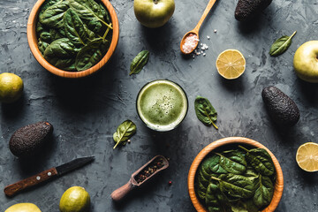 Spinach, apples, avocado, lemon smoothies, wooden background, wholesome food, eco, peeling, vegan.