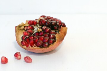 red ripe pomegranate fruit on white blurred background