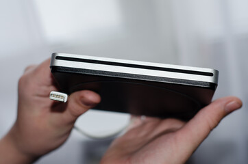  gray disk drive on  yellow background.  computer device that allows you to read and write information to removable media.