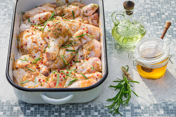 Seasoning raw and fresh chicken legs for grilling