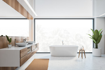 Wooden and white bathroom with white bathtub, sinks and window