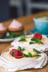 Meringue and whipped cream dessert layered with seasonal strawberry.