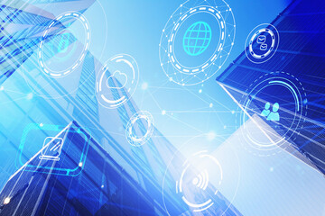 Naklejka premium Technology icons hologram on low, wide angle view of glass and steel contemporary skyscrapers in financial downtown. The concept of success in hi-tech industry. Double exposure.