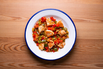 Chicken cooked with vegetables and potatoes.