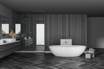 Interior of modern bathroom with gray walls, wooden floor, white bathtub and double sink with mirror on dark gray counter. 3d rendering