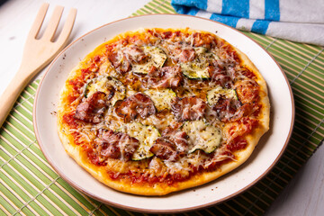 Pizza with vegetables and bacon, traditional italian recipe