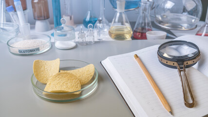 Food safety laboratory procedure, analysing potato chips from the market. Workplace lab assistant. Close up.