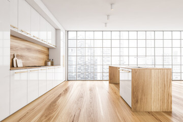 White and wooden dining room, kitchen near window with cutting table and parquet