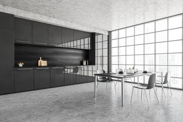 Black and grey kitchen and dining table with chairs near window