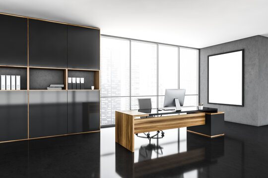 A CEO office interior with a wooden table, a computer standing on it, a framed poster on a grey wall. 3d rendering, mock up