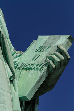 Detail of the tabula ansata held by the hand of the Statue of Liberty with the date of the US Declaration of Independence July 4th, 1776