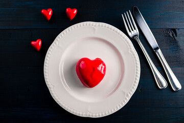 luxury romantic mousse cake in form heart served. sweet dessert red heart concept Valentine's Day on February 14. Dark Background