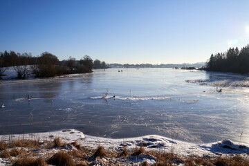 A sunday on the frozen local lake and river in Oslo, Bogstadvannet.  Norwegian families are out in the cold skating on the frozen river and lake. Not much snow, but really cold. 