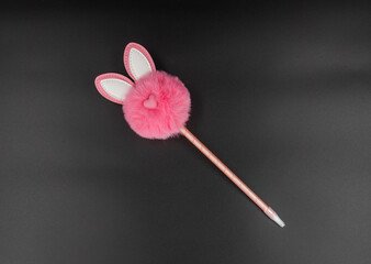 Pink fluffy toy on a stick