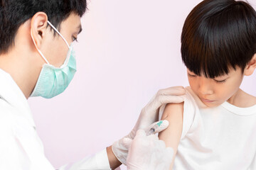 Doctor examining a child in a hospital. A happy kid is being vaccinated. doctor vaccinating little boy.