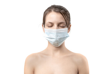 Portrait of a young caucasian sad woman in a medical mask with eyes closed on a white wall background. Girl patient, copy space