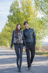 couple of young people are walking on a sunny day.