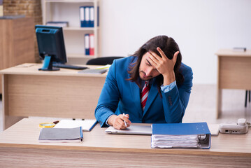 Young male employee working at workplace