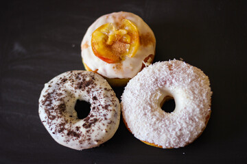 Three delicious Donuts on a black background