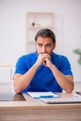 Young male doctor working in the clinic