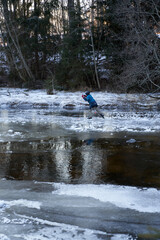 Naklejka premium A cold Sunday in January on the frozen local lake or river in just outside of Oslo city. Norwegian families are gathering on the ice for skating and having fun.