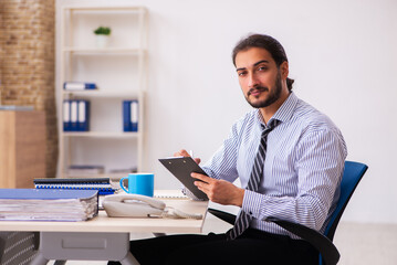 Young male employee working in the office