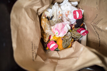 Stockholm Sweden A brown paper bag of organic waste in a kitchen.