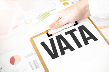 Text vata on white paper plate in businessman hands with financial diagram. Business concept