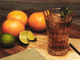 still life with juice and fruits,Still life, ice tea on board, with grapefruit, lime and mint