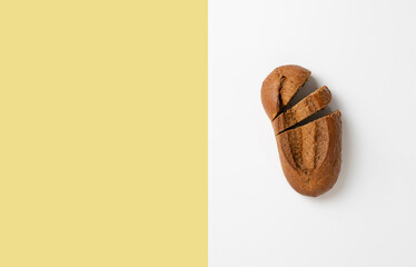 fresh dark baked bread loaf. simple siolated food top view