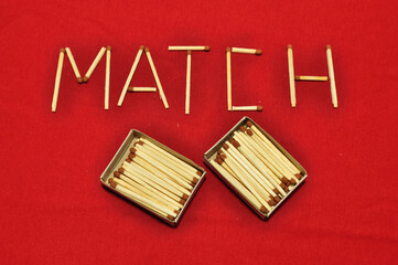 On the red cloth there are two matchboxes and the word “match” made up of matches. World match day.