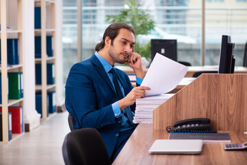 Young male employee working in the office