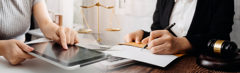 Business and lawyers discussing contract papers with brass scale on desk in office. Law, legal services, advice, justice and law concept picture with film grain effect