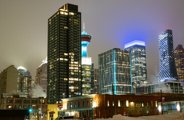 Fototapeta na wymiar A long exposure city scape of a busy downtown centre with office building lights and landmarks of Calgary Alberta at night.