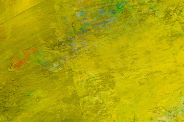 colorful creative motley background: smudged residues of oil paints on a wooden palette, short focus, selective blur