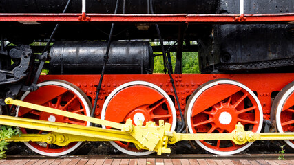 Close up image of locomotive wheels from an old fashioned steam train