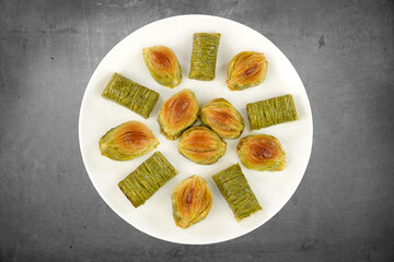 Turkish Midye Baklava  ( Mussel Shape Baklava ) with green pistachio nuts and Sarma ( Green pistachio wrap) 