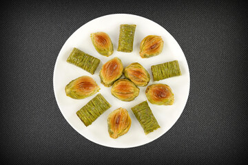 Turkish Midye Baklava  ( Mussel Shape Baklava ) and pistachio sarma dessert .  