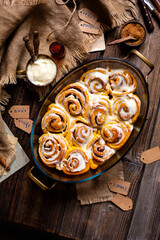 Tasty orange cinnamon swirled buns with white glaze on top