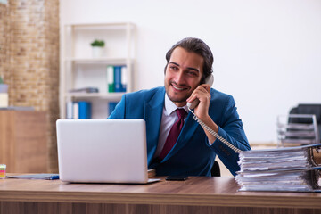 Young male employee working at workplace