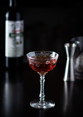 Manhattan craft cocktail with bottle and barware