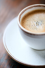  Cup of coffee on rustic wooden background. Close up.