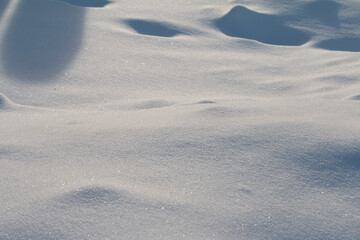 snow surface texture with sun backlight, cold winter weather photography
